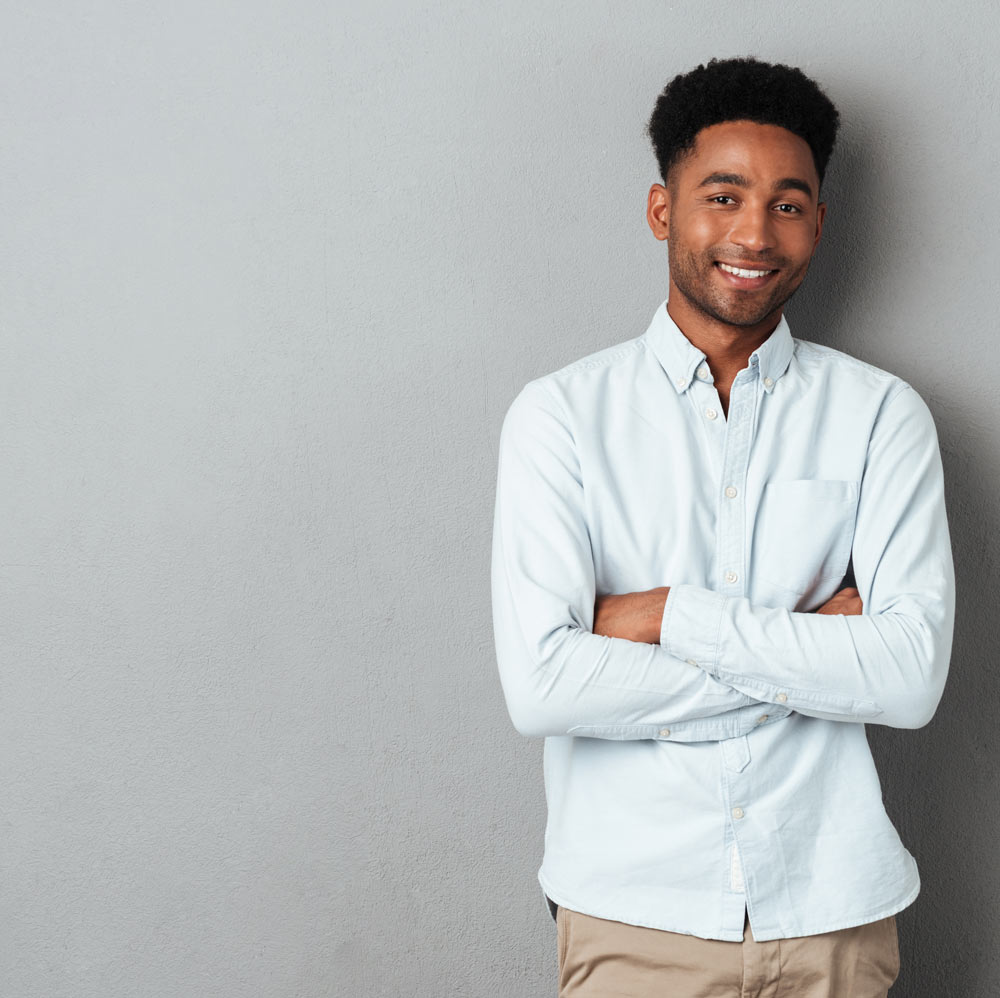 smiling-african-man-standing-with-arms-folded